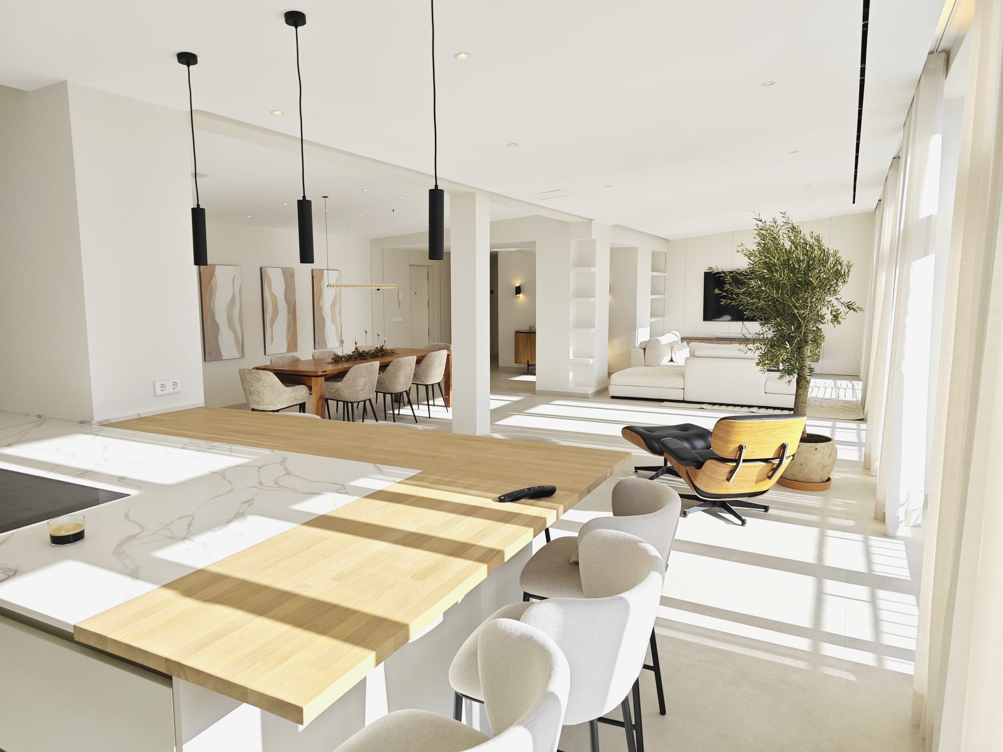Kitchen island with the dining table and living room beyond